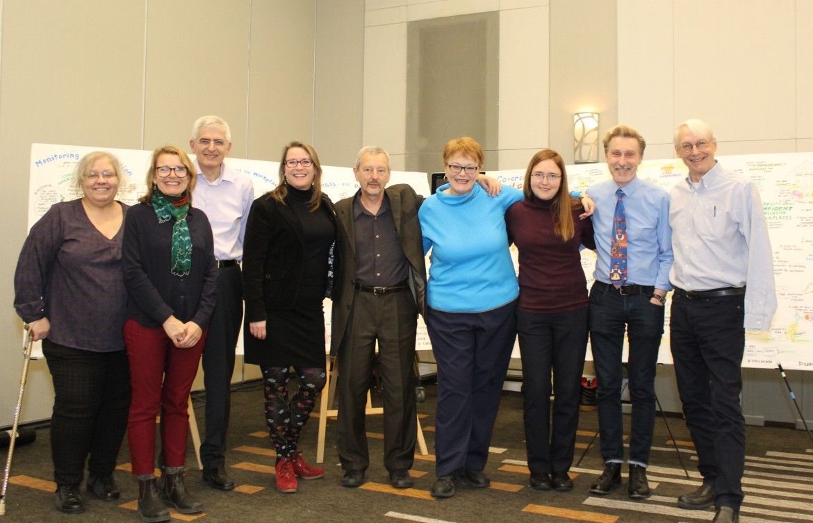 A group of nine people pose for a picture