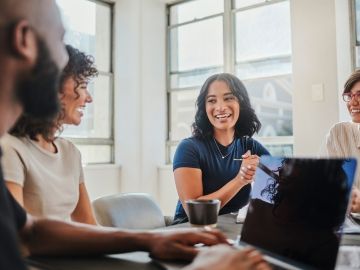 A group of young workers collaborate on a project