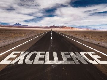 Excellence written on road way
