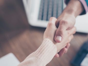 Two people shaking hands.