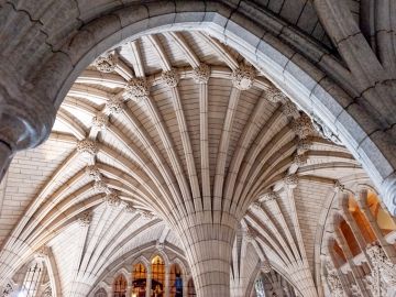 Stone arches and stain glass windows in the interior of the Canadian Parliament