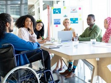 A group of people around a table, brainstorming