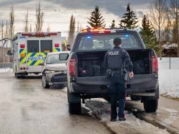 Paramedic and police vehicles at a roadside accident