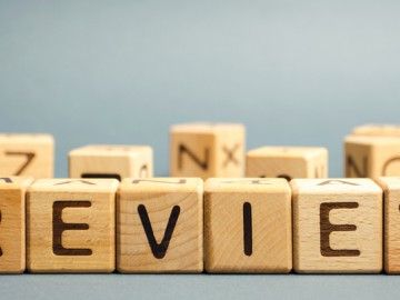 wooden letter tiles spell out the word "review"