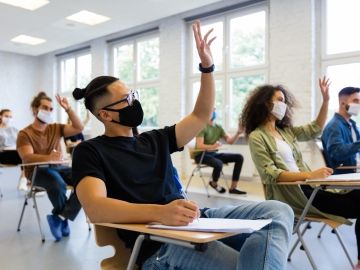 Masked university students in a classroom 