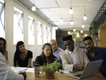 A group of workers in a well-lit office