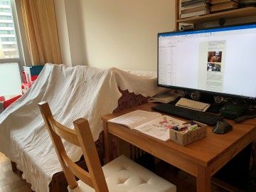 a computer workstation next to a children's tent fort