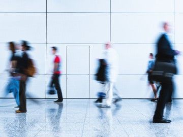 Blurred figures of workers walking