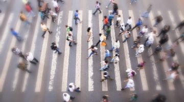 Overhead view of a crowd of people crossing an intersection