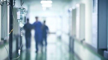 Group of doctors running down hospital hallway