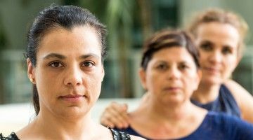 Three mature women look at camera