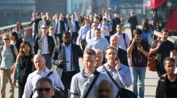 Photo of workers commuting to work on a wide walkway