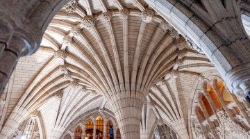 Stone arches and stain glass windows in the interior of the Canadian Parliament