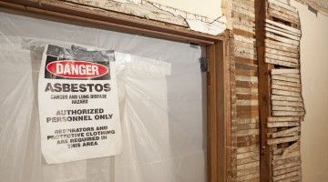 Sign on asbestos remove site warning of cancer and lung disease hazard due to asbestos exposure