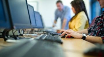 Blurry image of people at computer terminals