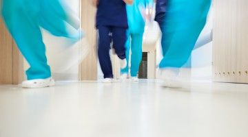 Blurry image of health-care workers running