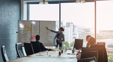 Group of executives meet in boardroom