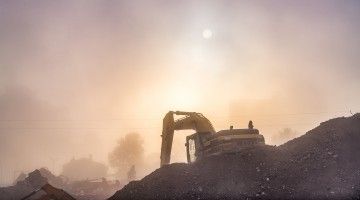 Construction equipment amid dusk and haze 