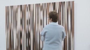 Back of woman facing artwork at museum