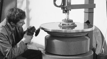 Young man does sanding work at machine 