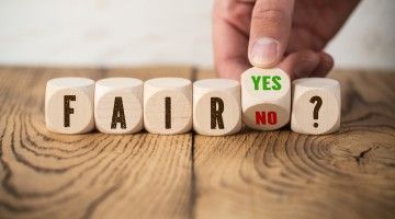 Wooden blocks spell out the words 'fair,' and 'yes or no?'