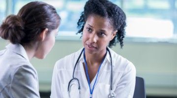 A female health-care professional consults with her patient