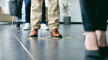 Close-up of floor markings indicating six feet distances