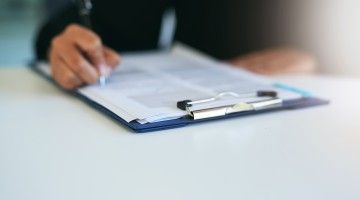 Close-up of a hand completing a checklist