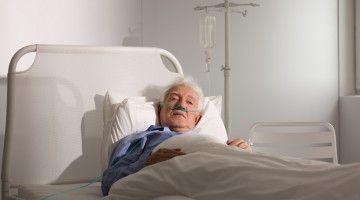 An elderly patient lying in bed