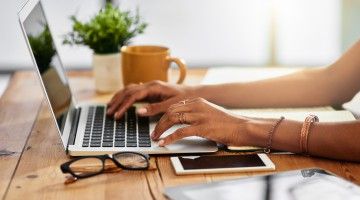 close up of person using laptop at home