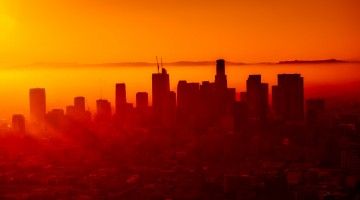 Los Angeles skyline cast in the orange glow of a sunset