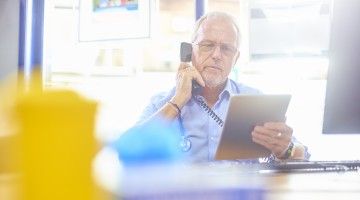 A doctor reviews a chart with someone over the phone