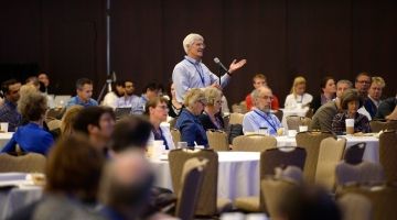 PREMUS conference delegate stands to ask a question