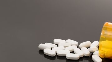 Pills spill from a prescription bottle