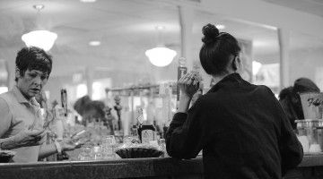 Two female servers at a restaurant bar