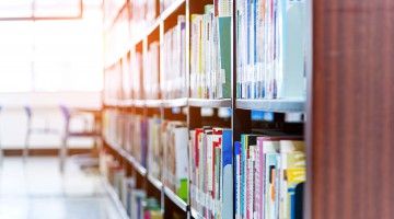 View of books on shelves in university library 