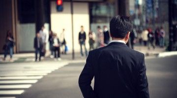 View from the back of a man in a suit in an urban street