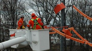 Utility workers fix cable