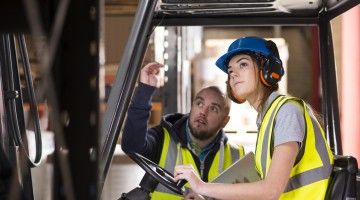 A forklift operator gets job training