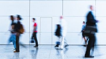 Blurred figures of workers walking