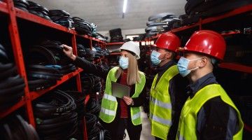 Workplace inspectors inspecting a workplace during COVID, as indicated by the masks they are wearing