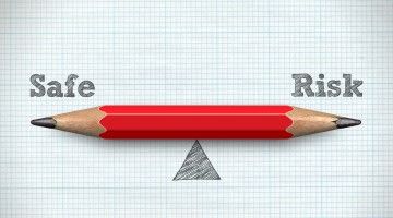 A red pencil evenly balances between Safe an Risk
