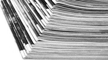Black and white photo of stack of magazines