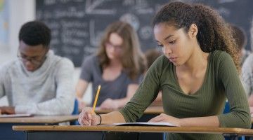 University students in classroom writing test
