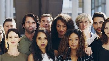 A group of young adults look into the camera