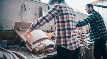 Young couple working at their small woodworking business