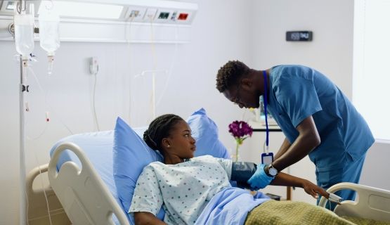 A nurse takes his patient's blood pressure.