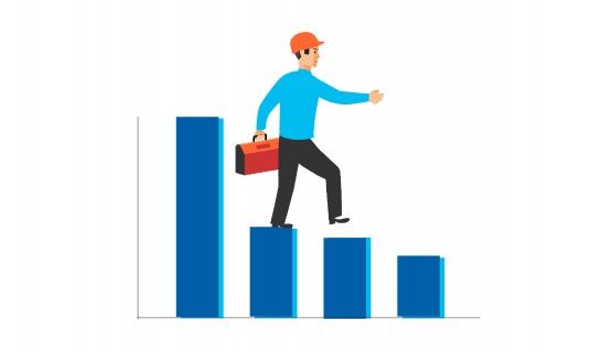 A man wearing a construction helmet and declining bar charts