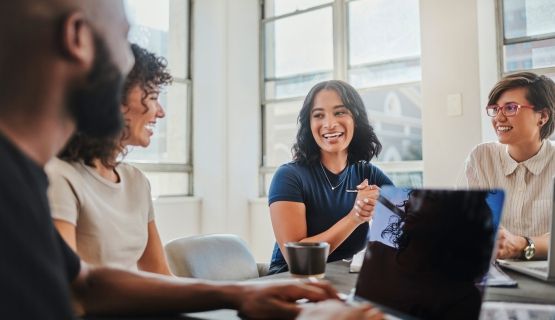 A group of young workers collaborate on a project