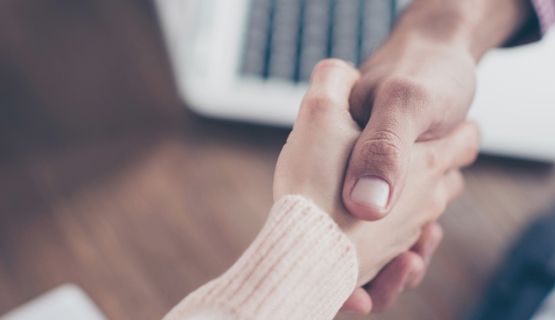 Two people shaking hands.